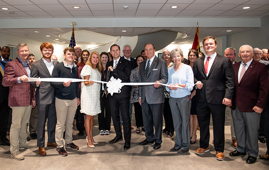 Mississippi State University’s downtown Innovation Hub today [April 4] hosted U.S. Congressman Michael Guest, center, his family, staff and visitors for the ribbon cutting at Guest’s new Downtown Starkville office in the Hub. Joining Guest, who represents the state’s District 3, for the official announcement were, from left, State Senator Bart Williams; Guest’s sons Kennedy and Patton, and wife Haley; MSU President Mark E. Keenum; Starkville Mayor Lynn Spruill; and Guest staff members Charlie Ballou and Harold Cross.