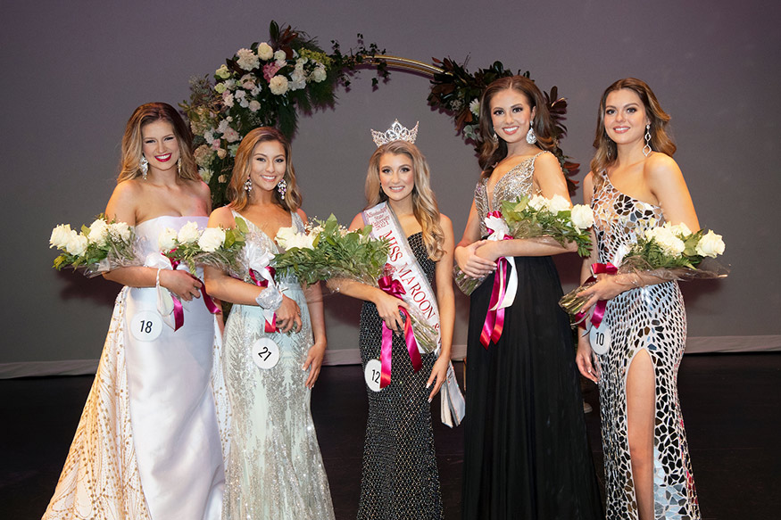 Five young women in the Miss Maroon and White program are pictured in formal gowns holding flowers