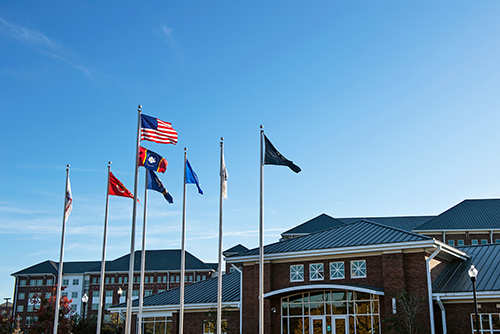 The U.S., Mississippi and military flags fly above Nusz Hall and the G.V. "Sonny" Montgomery Center for America's Veterans