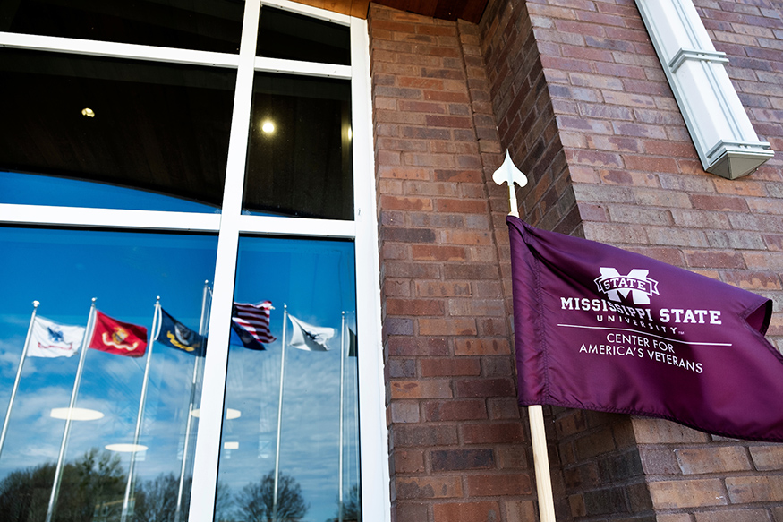 Flags are reflected in the windows of the G.V. "Sonny" Montgomery Center for America's Veterans