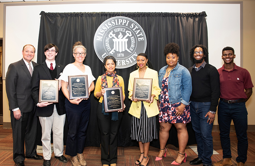 MSU President Mark E. Keenum presents the university’s 2019 Diversity Awards during a recent campus ceremony hosted by the President’s Commission on the Status of Minorities. Pictured with Keenum, far left, are award winners, from left, Tyler Daniel, student recipient, a senior political science major from Clinton; Elizabeth Englebretson, staff recipient, public design and landscape architecture intern at the MSU Gulf Coast Community Design Studio; Karina Zelaya, faculty recipient, assistant professor in the Department of Classical and Modern Languages and Literatures; and Society of African American Studies representatives Morgan Alexander of Clinton, Hailey Spillers of Terry, Joseph Neyland of Jackson and Mathieux Davis of Marietta, Georgia, team recipients. The annual awards recognize students, faculty and staff members for actions that enhance campus diversity. (Photo by Jarvis Mace)