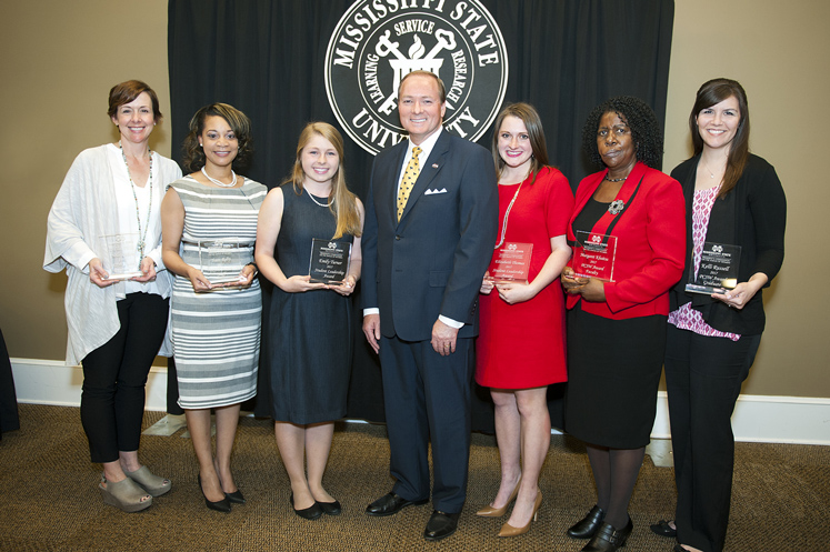 During an April 4 ceremony, Mississippi State University honored six individuals with 2017 President’s Commission on the Status of Women awards. Pictured with MSU President Mark E. Keenum, center, they include, from left to right, Nelle Cohen, Yvett Roby, Emily Turner, Betty Thomas, Margaret Khaitsa and Kelli Russell. (Photo by Russ Houston)