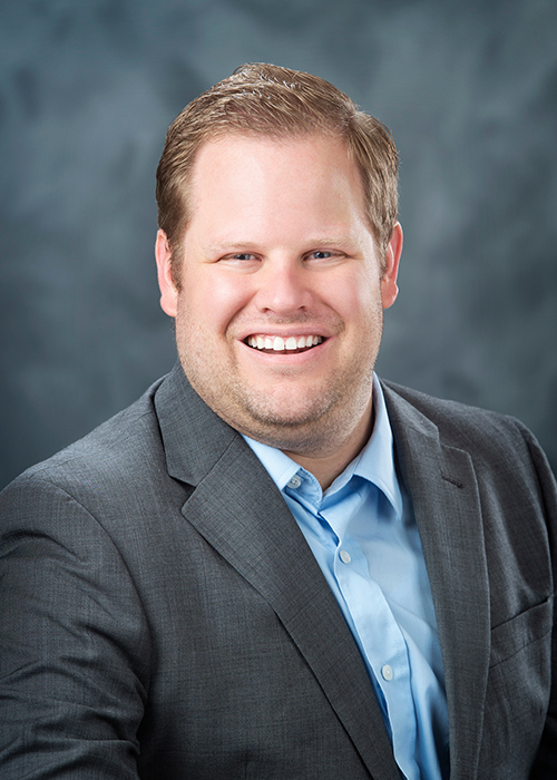 Close-up studio portrait of Tyler Page in front of a grey background