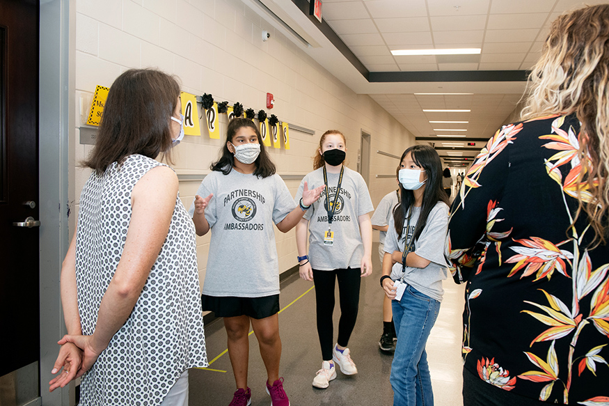 Seventh grade students give a tour to visitors at Partnership Middle School