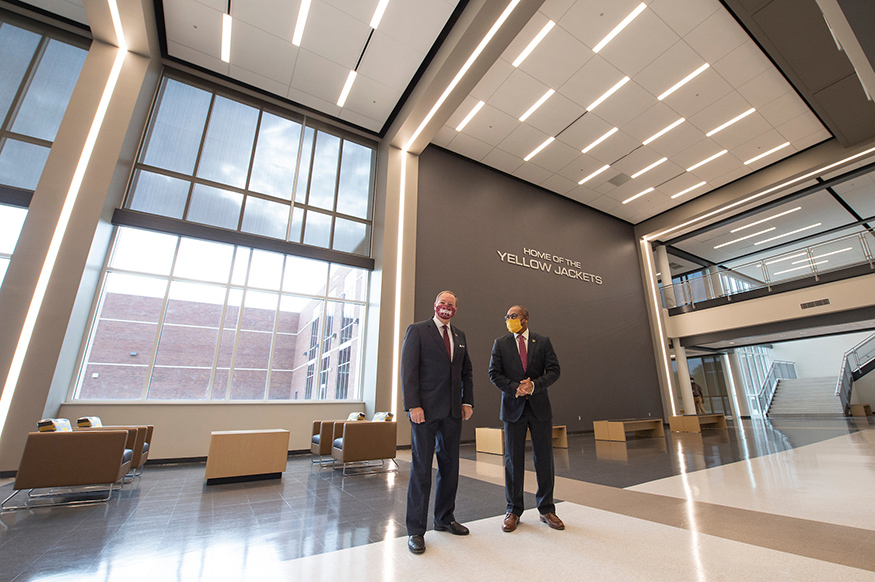 Mark Keenum and Eddie Peasant talk in the atrium of the Partnership Middle School