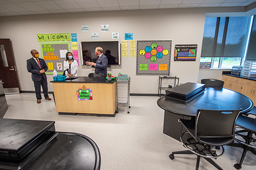 Ashley Allen shows off her science classroom to Mark Keenum and Eddie Peasant