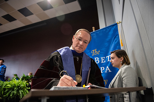 MSU President Mark E. Keenum signs the Phi Beta Kappa register of the new Gamma of Mississippi Chapter at Mississippi State University. Keenum was among eight Foundation members inducted April 2, along with 77 students who represent the inaugural Bulldog members. The chapter also includes 45 Phi Beta Kappa faculty and staff members. (Photo by Logan Kirkland)