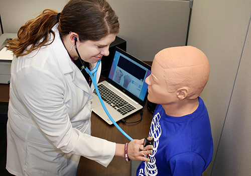 Tara Milligan, assistant clinical professor with MSU-Meridian's Master of Physician Assistant Studies program, demonstrates the Student Auscultation Model (SAM), which students can use to listen to normal and abnormal heart and lung sounds for cardiology and pulmonology classes. (Photo by Lisa Sollie)