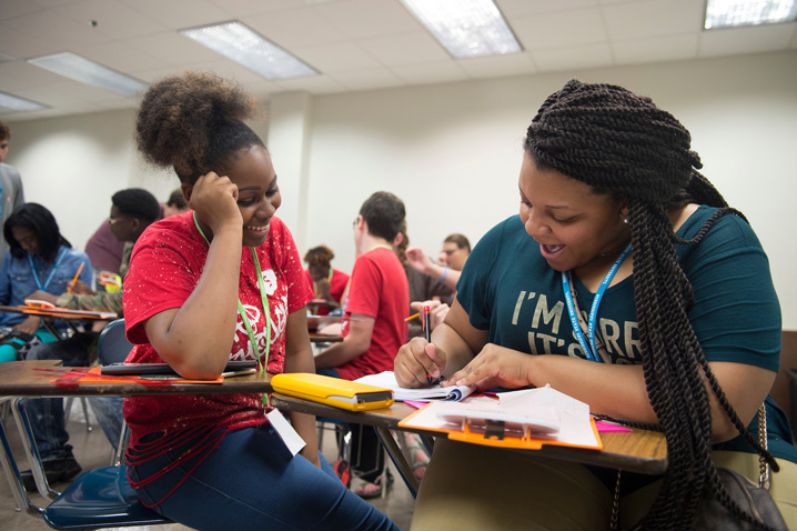 Jamaiya Fears (left) and Jala Scott, both Aberdeen High School students, make vector graphs of a “mine field” they created on MSU’s Drill Field as part of the AP physics summer preparatory academy. (Photo by Megan Bean)