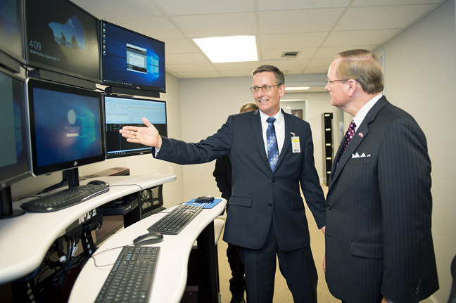 MSU Chief of Police Vance Rice shows one of MSUPD’s new dispatch stations to MSU President Mark E. Keenum during the Wednesday [Sept. 27] open house event. (Photo by Russ Houston)