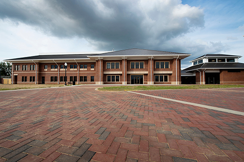 A large brick building with brick pavers in the foreground