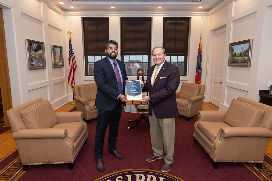 MSU President Mark E. Keenum presents Prashant Singh with an award from ORAU.