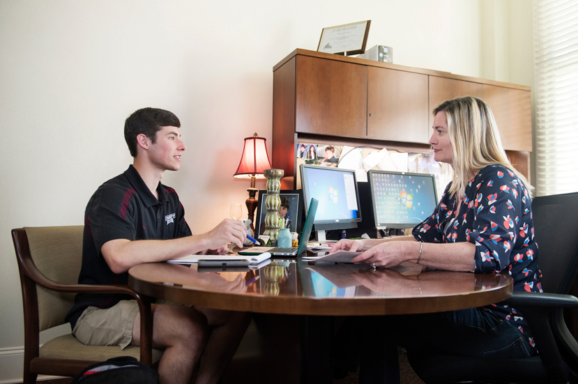 Mary Celeste Reese, director of the Dr. A. Randle and Marilyn W. White Pre-Med Advisory Office, advises graduating senior Graham Garvey, a biochemistry major from Madison that will enroll in dental school at the University of Mississippi Medical Center this fall. (Photo by Megan Bean)