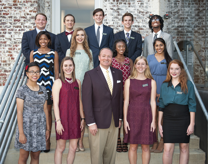 President Mark E. Keenum (first row, center) welcomes the newest class of MSU Presidential Scholars. From left to right, they include (first row) Joy Carino, Carley Bowers, Alicia Brown, Katelyn Provine, (second) Donielle Allen, Leah Boyd, Dajaina Martin, Krishna Desai, (third) Garhett Moseley, Samuel Lucas, Seth Lenoir, Benjamin Jones and Joseph Neyland. (Photo by Russ Houston)