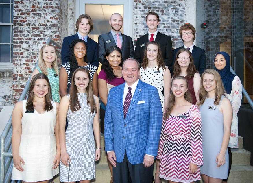President Mark E. Keenum (first row, center) welcomes the newest class of Mississippi State University Presidential Scholars. From left to right, they include (first row) Anna Shepard, Caroline Sleeper, Karson Pettit and Anna Mitchell; (second) Lindsey Downs, Jayla Mondy, Jasmine Topps, Cailin Sims, Laura Ingouf and Nada Abdel-Aziz; (third) Jack Davis, Choteau Kammel, Braden Garrison and Eli Riser. (Photo by Russ Houston)