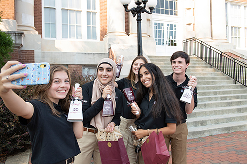 Five students take a selfie photo with their new cowbells, which MSU President Mark Keenum gave to the new class of Presidential Scholars