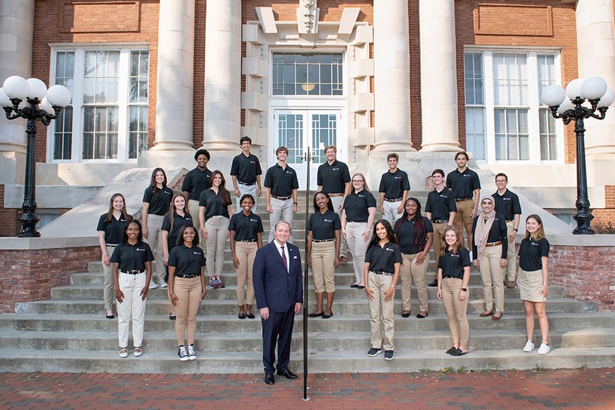 Twenty-two new Presidential Scholars are pictured with MSU President Mark Keenum on the steps outside Lee Hall