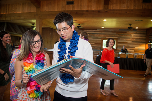 MSU ACCESS program students gathered with guests for a reception at the end of the spring semester to celebrate their accomplishments. ACCESS student Rebecca Abney, left, shows her portfolio from the year to kinesiology doctoral student Yonjoong Ryuh, who helped instruct an adapted physical activity class. (Photo by Megan Bean)