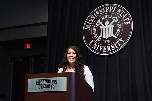 Senior psychology major Brittany A. Stansel of Corinth recognizes donors, faculty, staff and administrators who have made an impact on Mississippi State University’s Promise Program. Stansel is among the program’s graduating seniors who received an engraved cowbell and photo with MSU President Mark E. Keenum during a recent ceremony. (Photo by Beth Wynn)