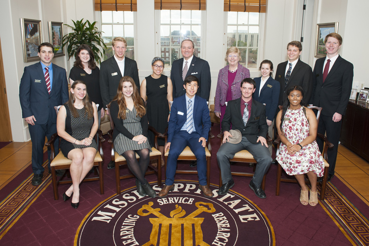 President Mark E. Keenum (back row, center) and Provost and Executive Vice President Judy Bonner (back row, fourth from right) welcome the newest class of MSU Provost Scholars. From left to right, they include (front row) Sarah Frey, Amye McDonald, James Grant, Will Jarrell and Latonia Parker (back row) Seth Barger, Wellesley Dittmar, Harrison Hunter, Sarah Claxton, Keenum, Bonner, Lucie Henein, Matthew Shine and Jacob Easley. Not pictured are Tyler Etheridge and Jennifer Sublett. (Photo by Russ Houston)