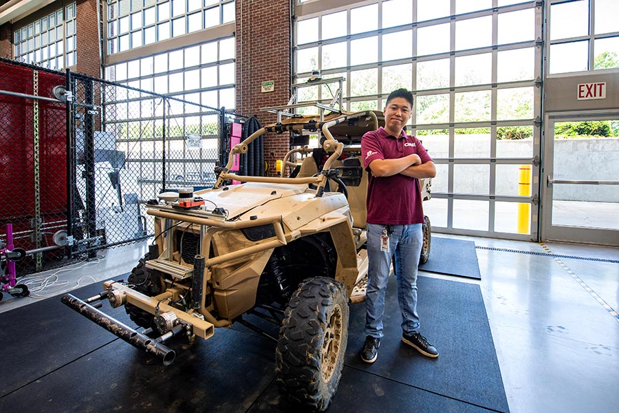 Man standing in front of a vehicle