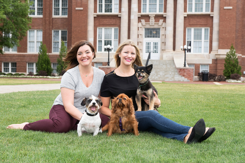 Petal natives Sarah and Kate Schraeder, pictured with their three dogs on Mississippi State University’s Drill Field, will graduate from MSU’s College of Veterinary Medicine on Friday [May 5]. (Photo by Beth Wynn)