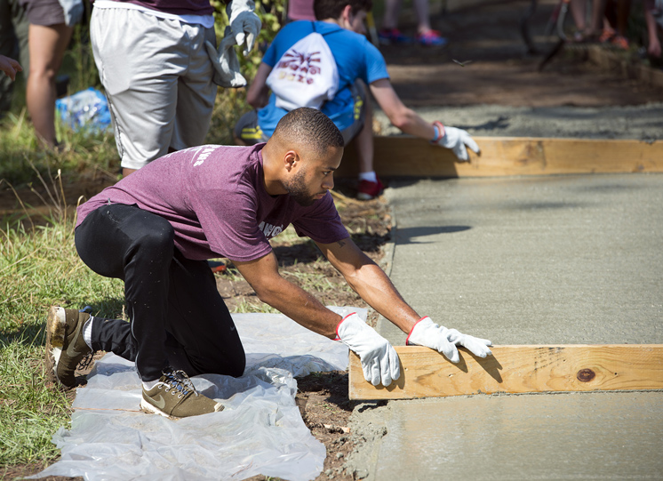 An MSU student works on a walkway at the Sam D. Hamilton Noxubee National Wildlife Refuge as part of Service DAWGS Day in August, one of many programs designed to engage students in civic activity. (Photo by Russ Houston) 