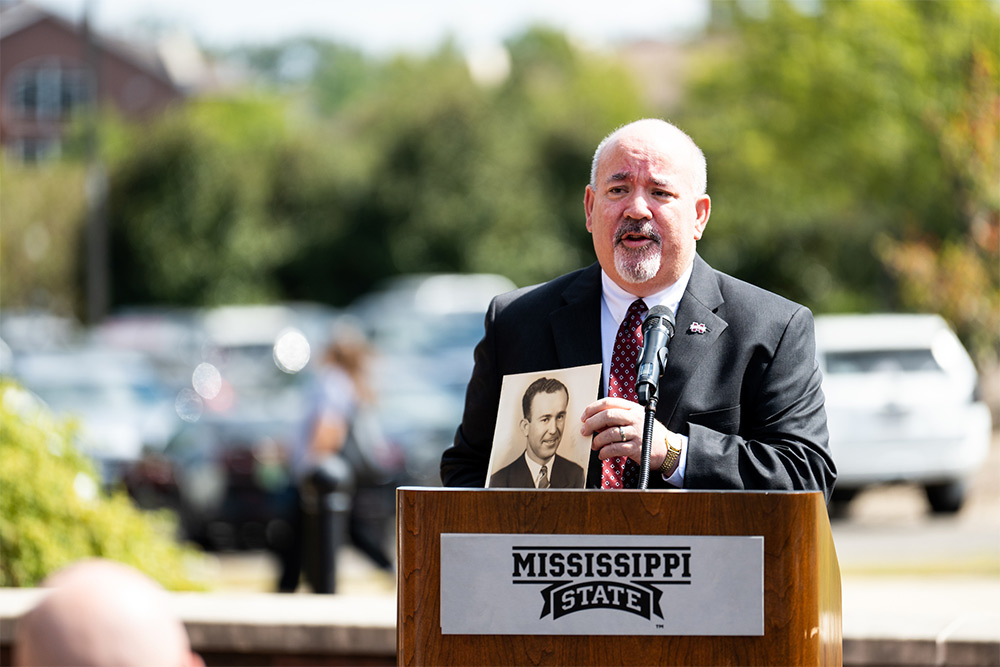 MSU Vice President for Strategic Communications Sid Salter shows a photo of his late father, Leo Salter, an MSU alumnus and WWII veteran who fought at the Battle of Normandy on D-Day. (Photo by Grace Cockrell)