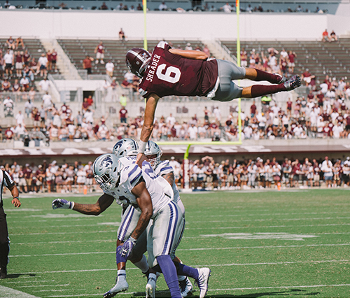 MSU quarterback Garrett Shrader spins high in the air during the 2019 MSU vs. Kansas State football game.