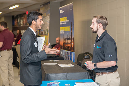 An MSU student talks with an employer representative during Career Days.
