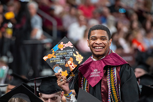 Cameron Mayers, a communication and political science double major from Pearl, shows off an inspiring message written on his graduation cap.