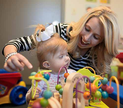 Kasee Stratton-Gadkee works with a young girl