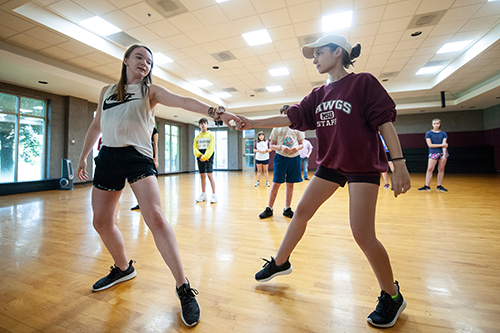 Grace Bass of Ripley, left, and Samantha Turner of Starkville teach Summer Scholars Onstage Camp participants a dance for Friday and Saturday [July 19 and 20] public performances of a three-act musical comedy called “The Pitch.” (Photo by Logan Kirkland)