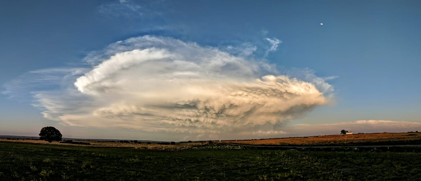 A supercell moves across a rural area