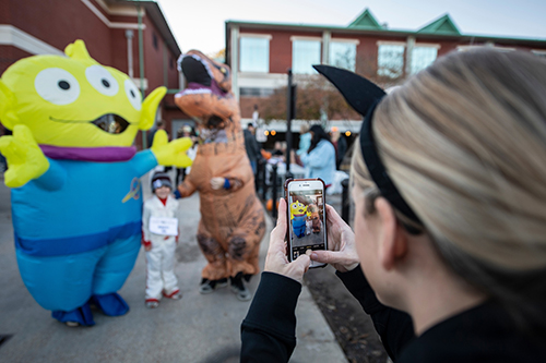 Participants of a past “Trick or Trot” fun run in costume pose for a picture near MSU’s T.K. Martin Center for Technology and Disability. 