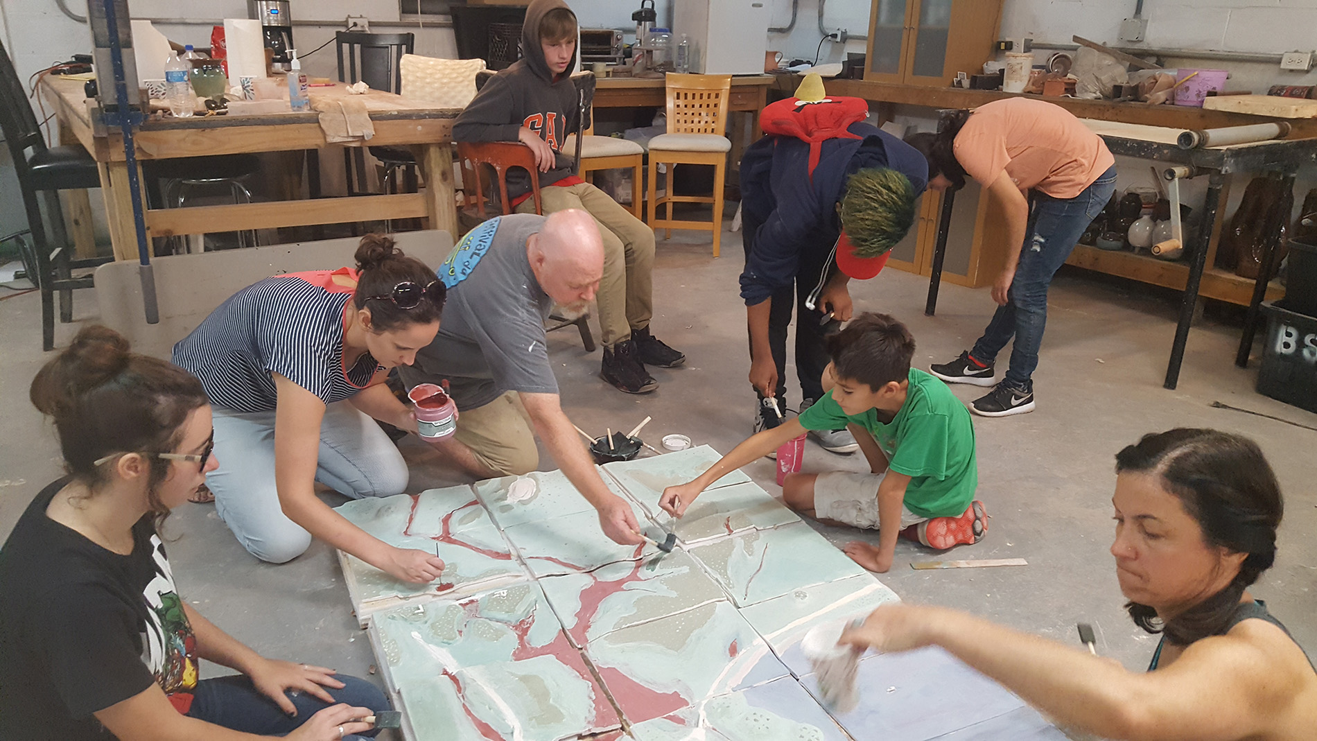 Youth from the Hancock County Unit of the Boys and Girls Club work with artists from their local community on a 3D tile model of the Magnolia Bayou watershed. The tile model is part of a multi-media art exhibition in Bay St. Louis that highlights watershed dynamics, water quality and quantity, and watershed planning and action. (Submitted photo/courtesy of MSU Gulf Coast Community Design Studio)