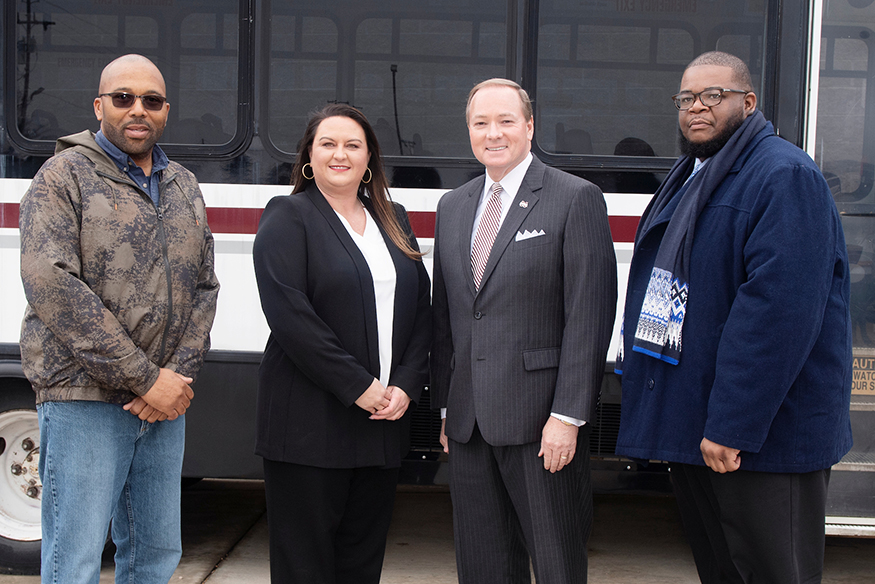 MSU and Oktibbeha County Leaders gathered Friday [March 1] to present a retired MSU transit bus to Oktibbeha County Emergency Management Agency. The bus will be converted into a mobile emergency management vehicle. Pictured, from left, is Oktibbeha County Board of Supervisors President Orlando Trainer, OCEMA Director Kristen Campanella, MSU President Mark E. Keenum and OCEMA Deputy Director Jarvis Boyd. (Photo by Beth Wynn)