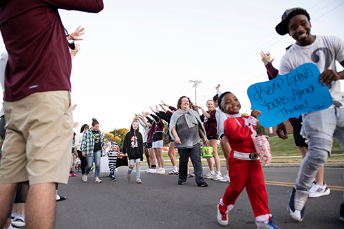 Sepctators cheer on participants during the Trick or Trot fun run in 2021