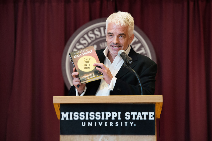 Pulitzer-Prize nominated journalist and novelist Neely Tucker reads excerpts from his newest book, “Only the Hunted Run,” to members of the campus and local communities gathered Friday [Aug. 19] at Mississippi State’s Mitchell Memorial Library. During an afternoon program in the John Grisham Room, the Starkville Academy graduate who attended Mississippi State officially donated a collection of papers to the university libraries’ Special Collections department. (Photo by Megan Bean)