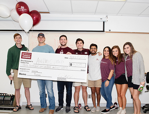 Tuition winner Austin Bishop, second from left, is pictured with Alumni Delegates, from left, Joe Arata, Andrew Martin, Jake Hughes, Osvaldo Ballesteros, Gracie Chavez, Anna May and Kylie Watts. (Photo by Beth Wynn) 
