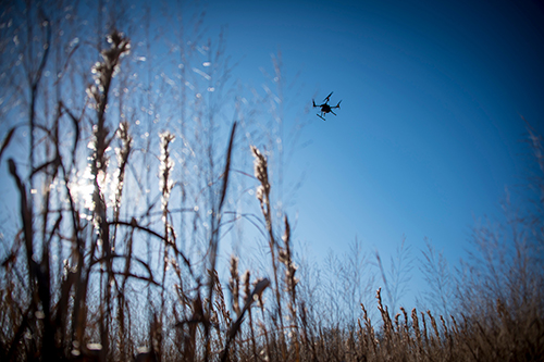 A UAV flies over a field.
