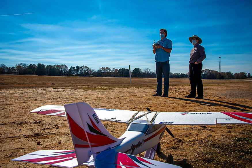 Kevin Wise of Scott, a master’s student in agriculture concentrating in agricultural engineering technology and business, operates an aircraft while Amelia Fox, assistant clinical professor in the MSU Department of Plant and Soil Sciences provides instruction. In the foreground is the E-flite Apprentice trainer aircraft. 
