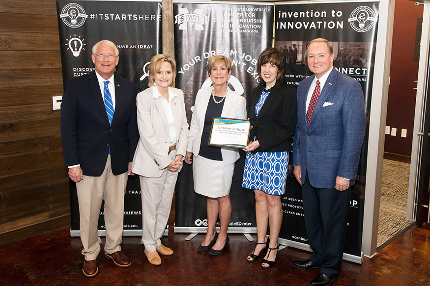 Celebrating a new $100,000 USDA Rural Business Development Grant for Mississippi State’s Center for Entrepreneurship and Outreach to open a makerspace in Downtown Starkville are, from left, Sen. Roger Wicker, Sen. Cindy Hyde-Smith, MSU College of Business Dean Sharon Oswald, USDA Assistant to the Secretary for Rural Development Anne Hazlett, and MSU President Mark E. Keenum. (Photo by Beth Wynn) 