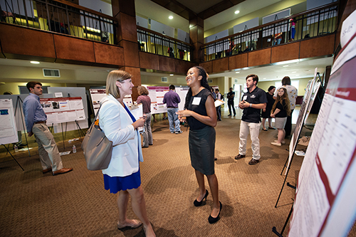 Assistant Professor Holli Seitz of Mississippi State’s Department of Communication speaks with senior civil engineering major Alexis L. Murrell of Vicksburg during the university’s Summer Undergraduate Research Symposium. For her project titled “Parental Attachment and Emotional Regulation on Affect after a Social Exclusion Task,” Murrell was advised by Associate Professor of Psychology Cliff McKinney. (Photo by Megan Bean)