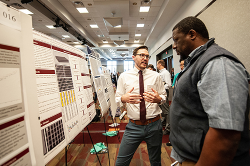 Senior industrial engineering student Kelson J. Bohna of Starkville, left, presents his project “Geometric Accuracy of 3D Printed Scaffolds based on Automatic Image Segmentation” to Jean Magloire Nguekam Feugang, associate research professor in the Department of Animal and Dairy Sciences, during Mississippi State’s Spring Undergraduate Research Symposium. (Photo by Logan Kirkland)