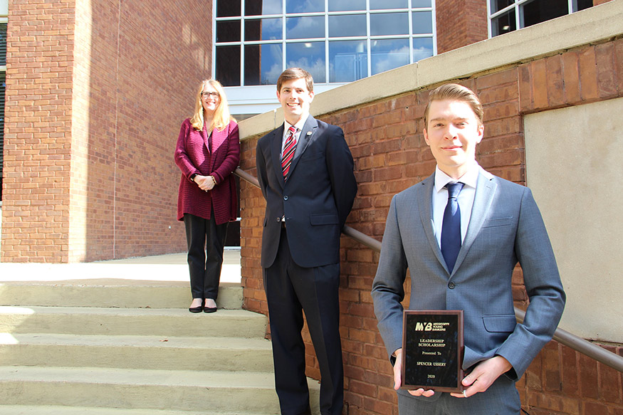 Spencer Ussery, front right, a junior finance major at Mississippi State receiving the Leadership Scholarship from the Mississippi Young Bankers section of the Mississippi Bankers Association, is pictured with Assistant Professor of Finance and Economics Brian Blank and Department Head Kathleen Thomas.