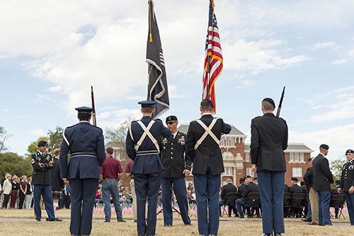An ROTC color guard presents the flags at a Veterans Day ceremony.