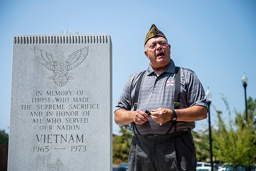 Bob Kirkland, an MSU alumnus and Vietnam War veteran, speaks in front of the university’s Vietnam War Memorial. (Photo by Logan Kirkland)