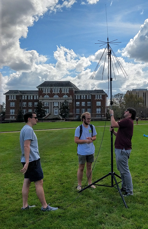 Patrick Younes, Colby Stevens and Logan Betts of Mississippi State’s Amateur Radio Club, W5YD, set up an antenna on the Drill Field as part of a club recruitment event.