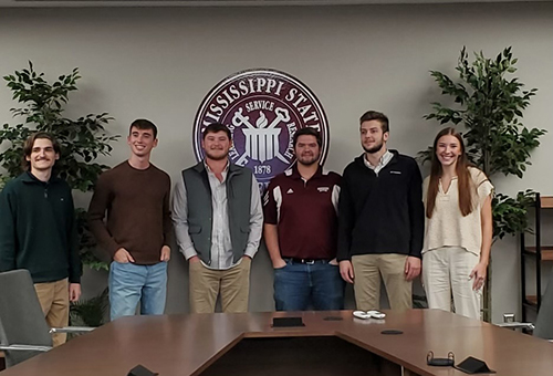 A group of students pictured in a conference room